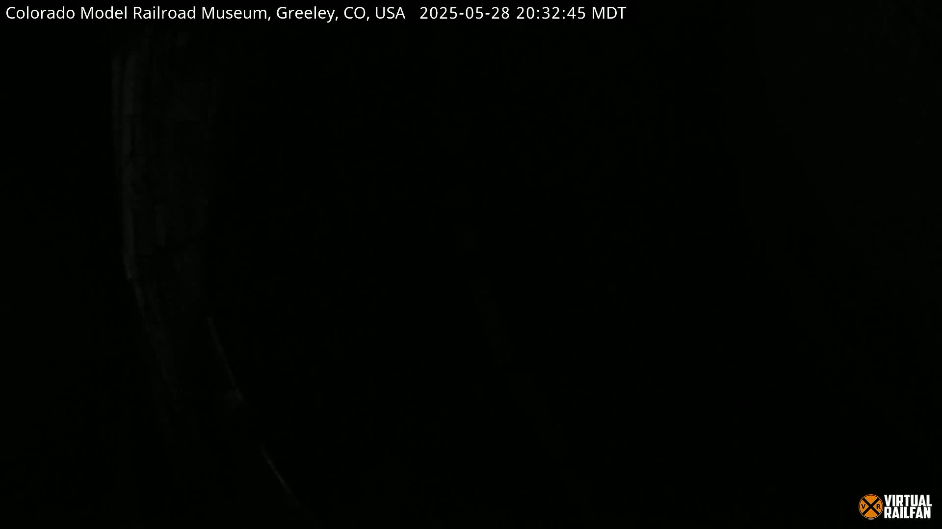 A very dark image shows a faint, blurry, vertical light source on the left.