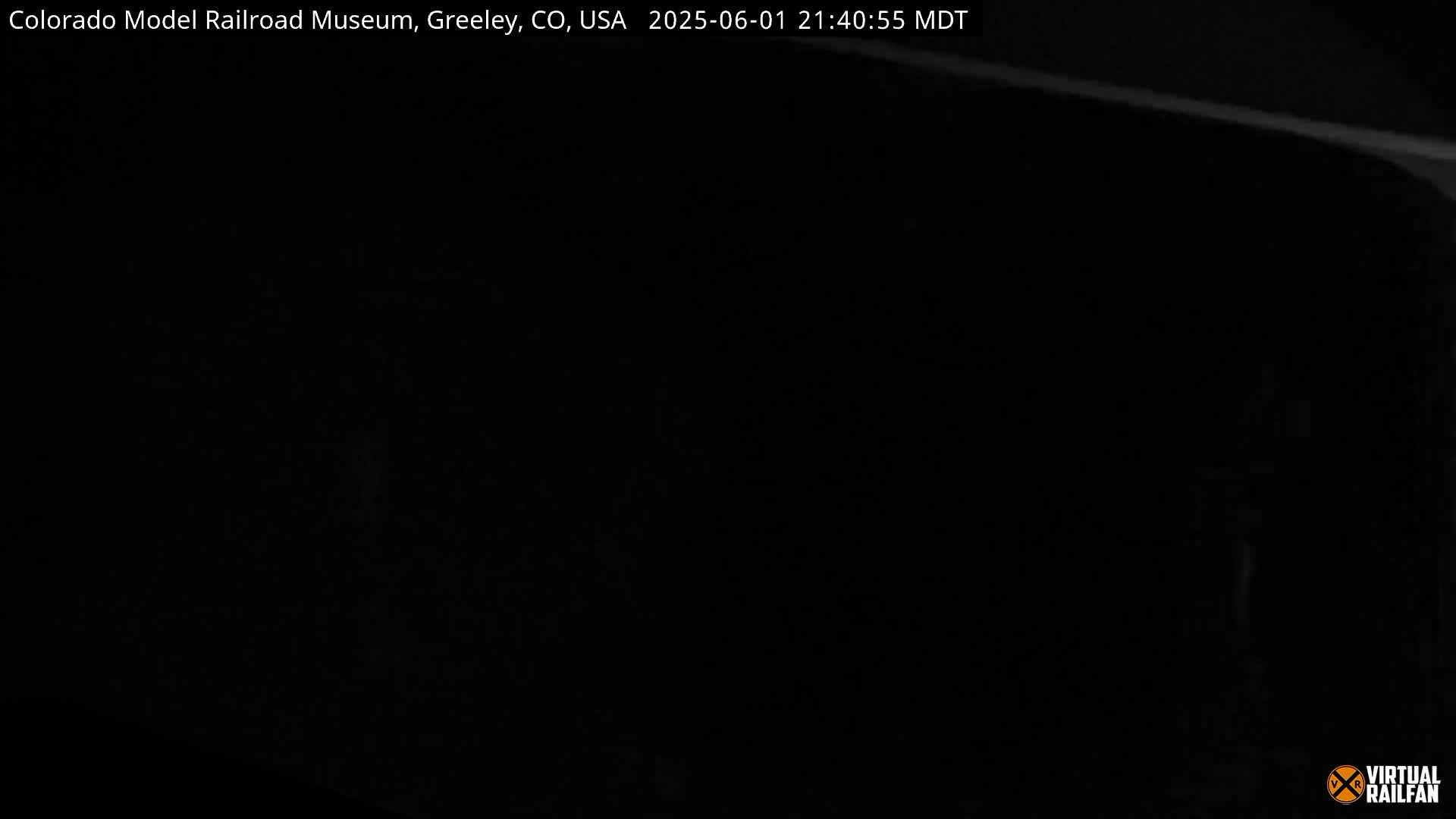 A mostly black image shows a faint, bright line in the upper right corner, suggesting nighttime conditions.