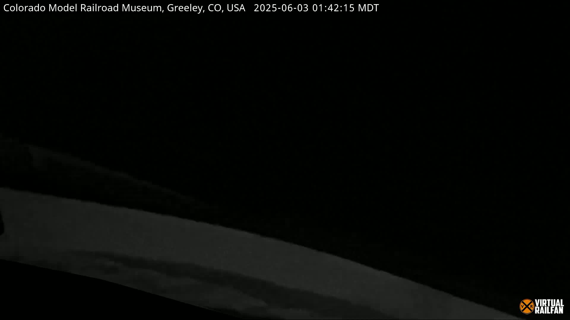 A mostly dark image shows a blurry, light-grey horizontal line at the bottom, suggesting nighttime conditions.
