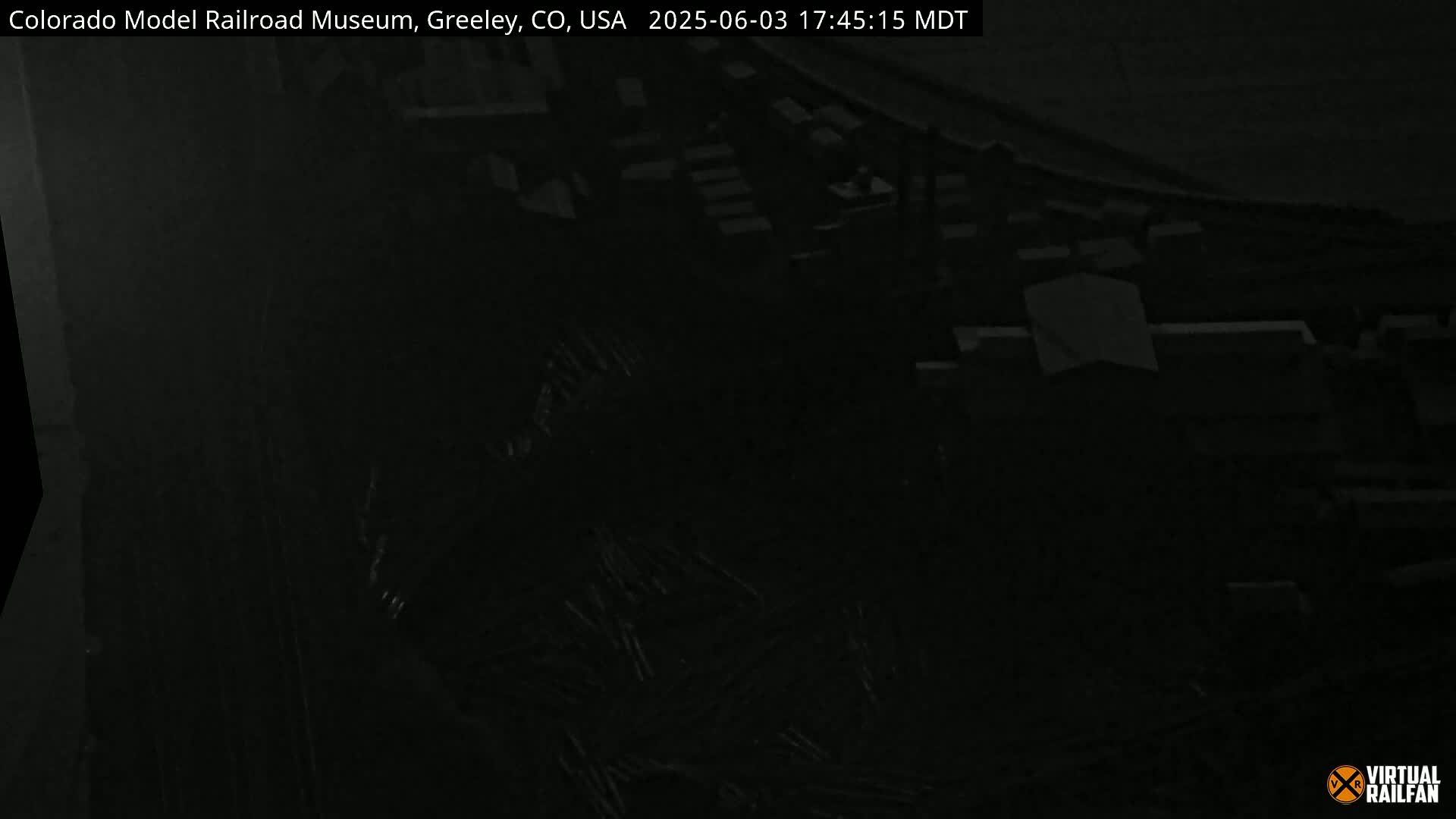 A dark, nighttime image shows an indistinct view of an area, possibly a building or cityscape.