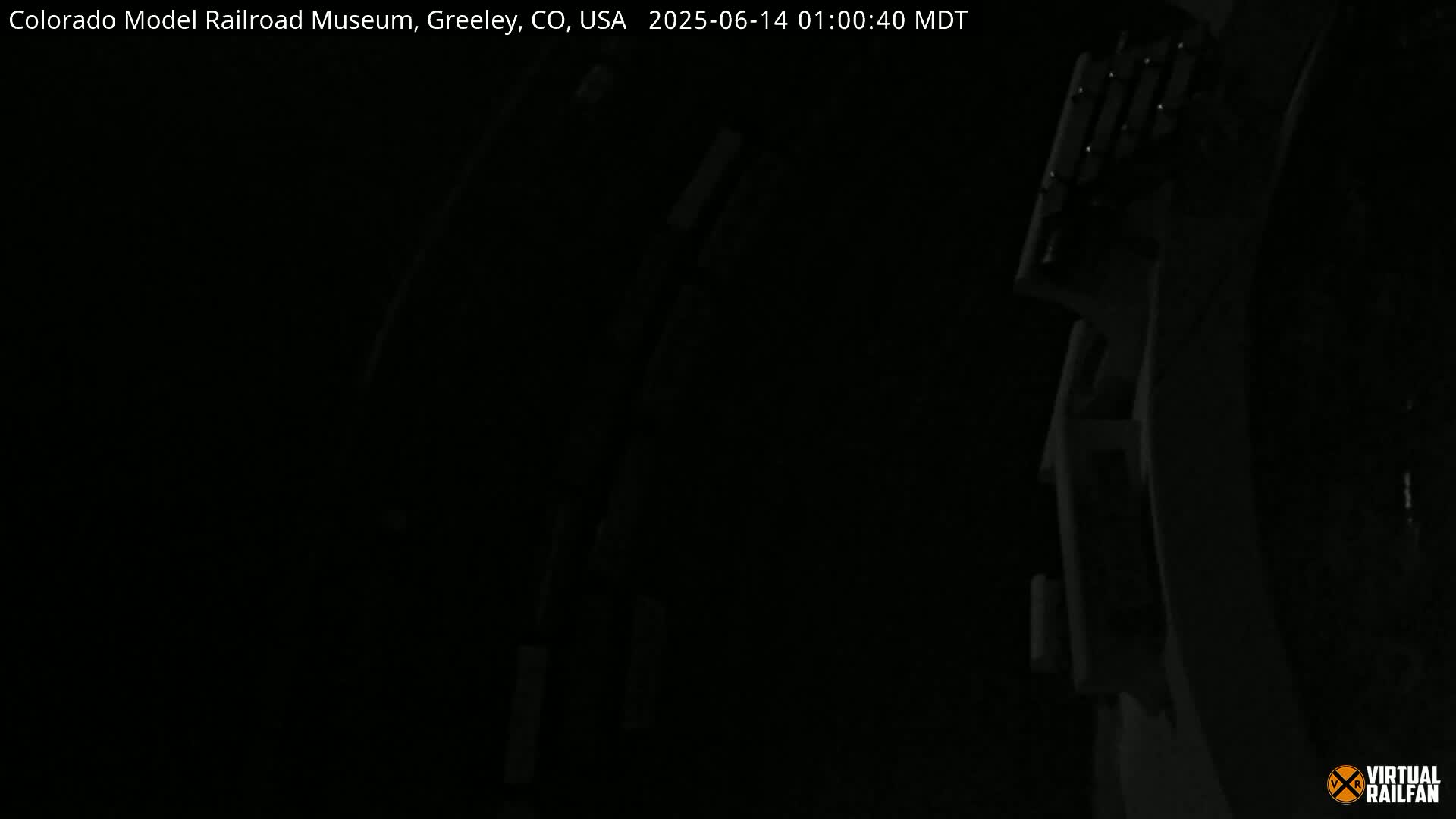A dark image shows a portion of a dimly lit structure, possibly a piece of machinery or equipment.