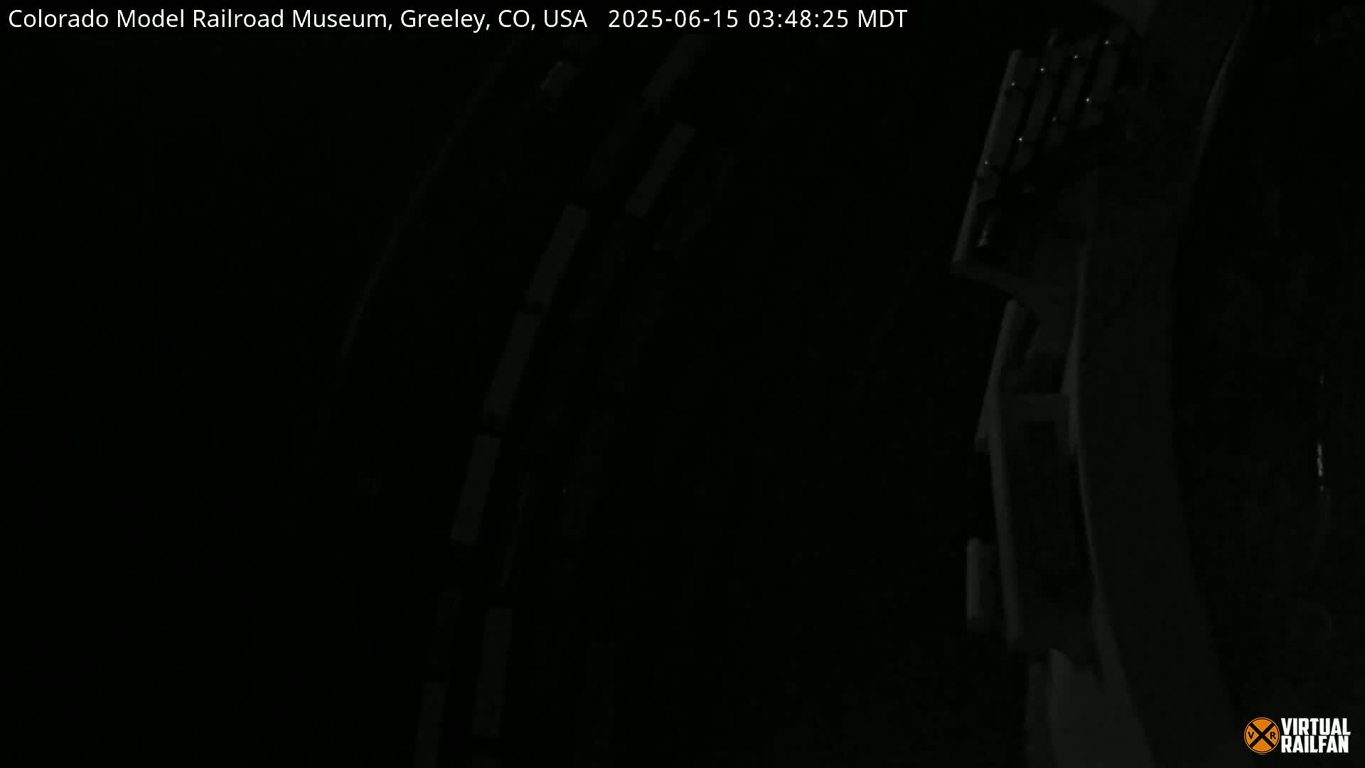 A dark, nighttime image shows a portion of a structure with visible details, suggesting it's indoors.