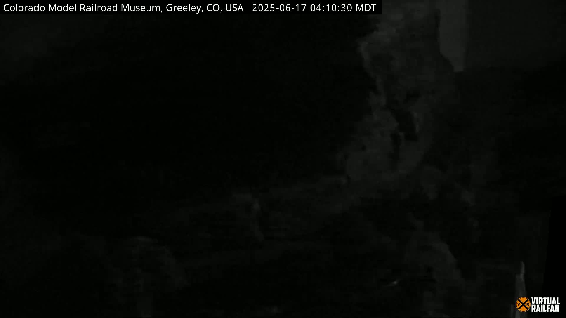 A dark, blurry image shows indistinct shapes and what appears to be smoke or fog.