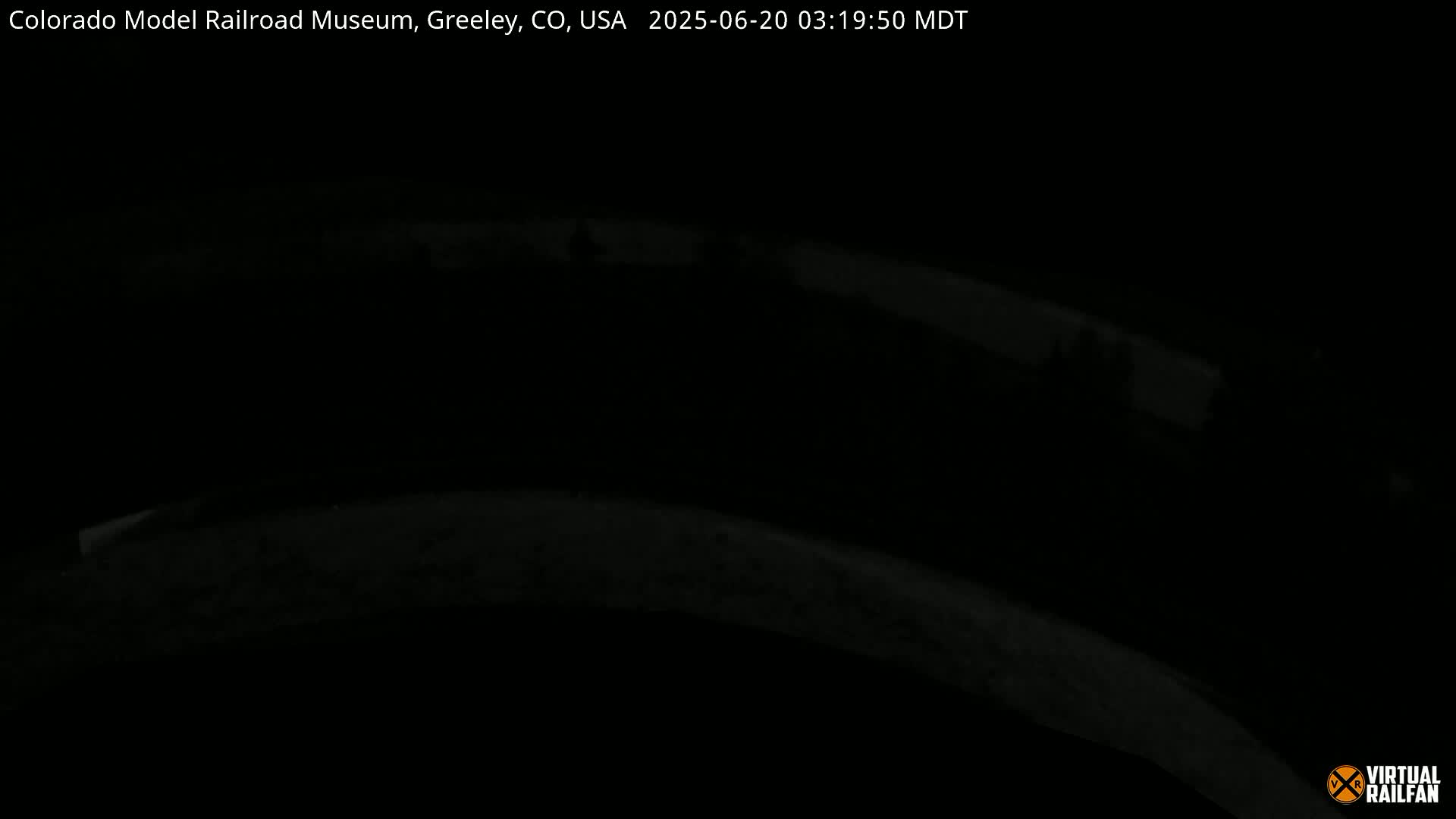 A dark, nighttime image shows a curved, indistinct surface.