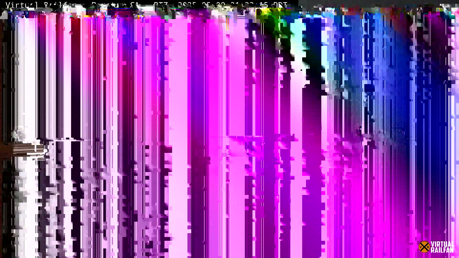 A heavily distorted image displays vertical streaks of purple, pink, and blue.