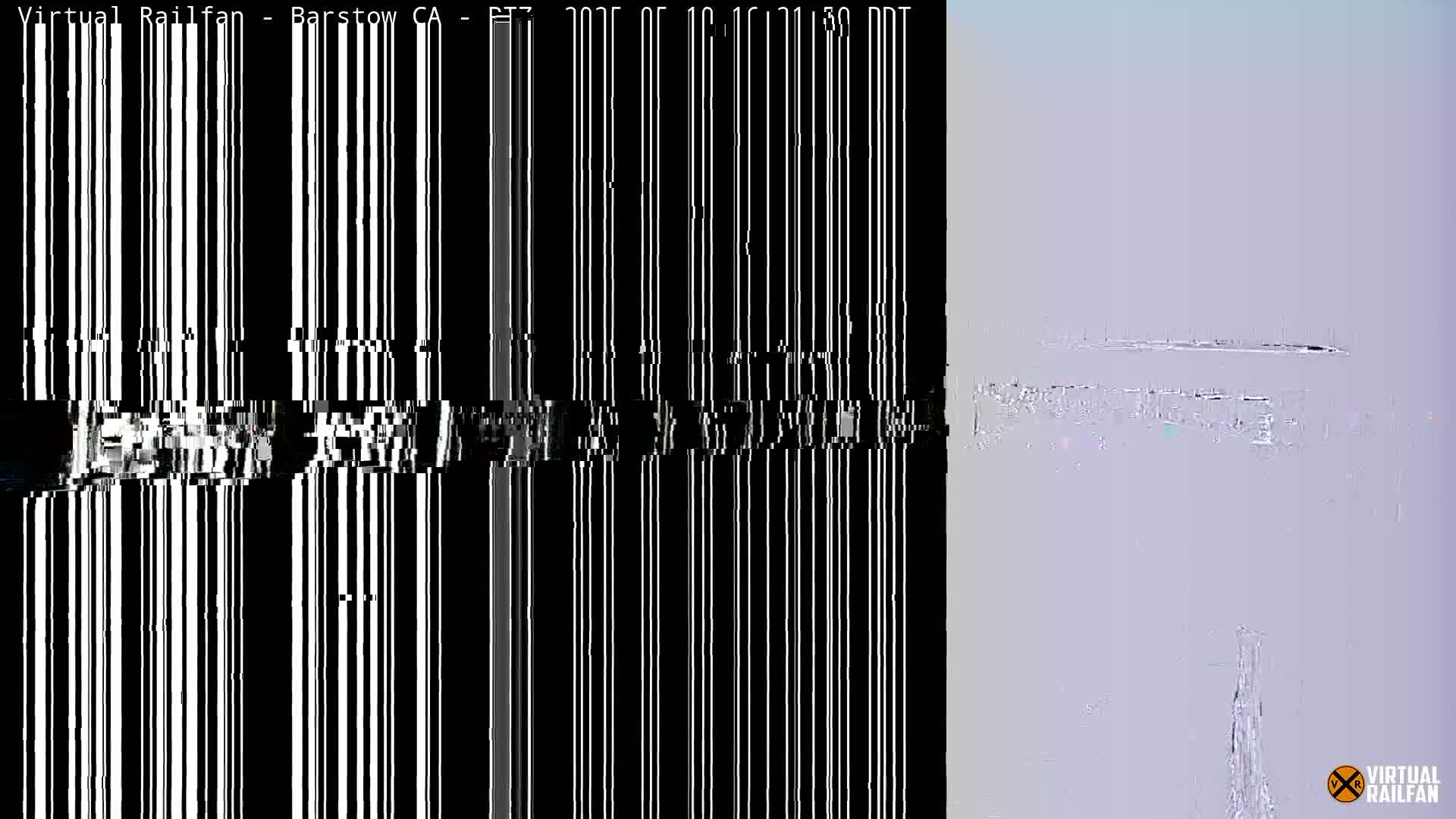 The image shows a mostly obscured view of a landscape under a hazy sky, with a heavily distorted section on the left.