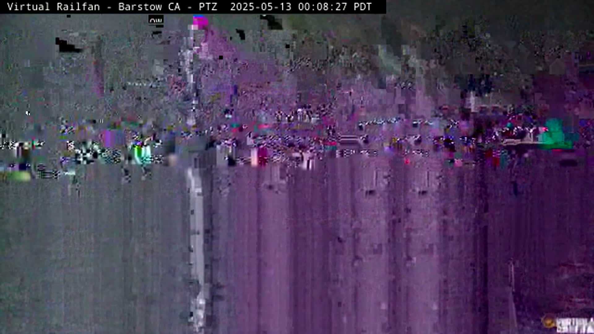 A heavily pixelated and distorted image shows an outdoor scene at night.