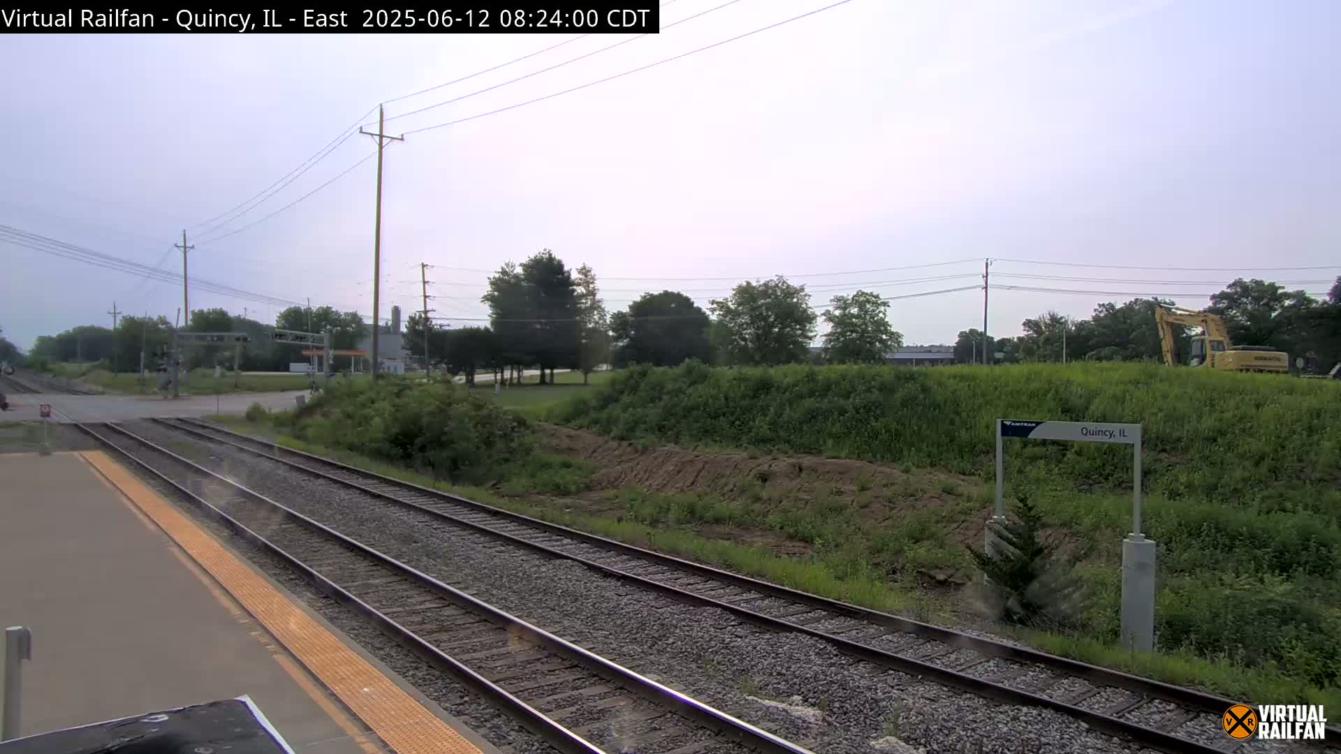 A train approaches a station in Quincy, Illinois, on an overcast day.