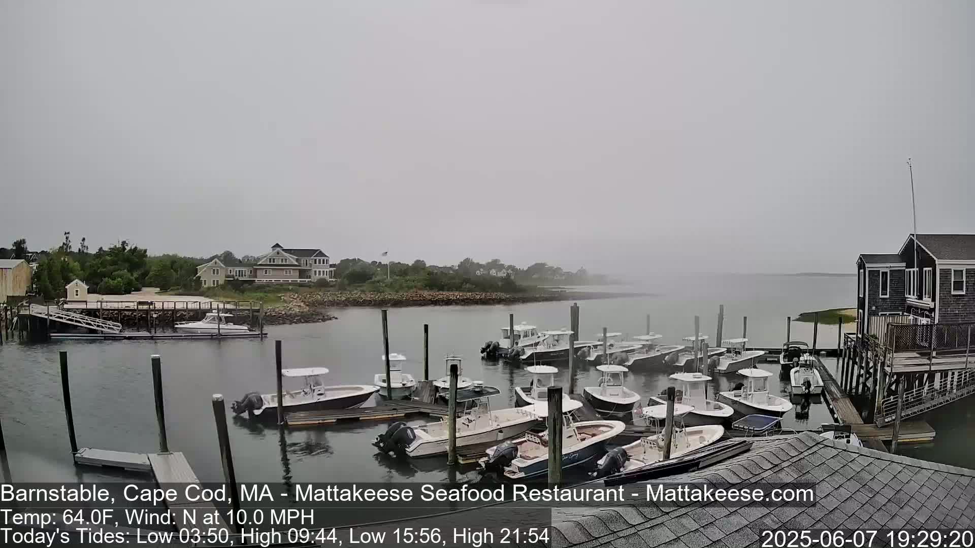 Many small motorboats are docked at a marina on an overcast day with a north wind.