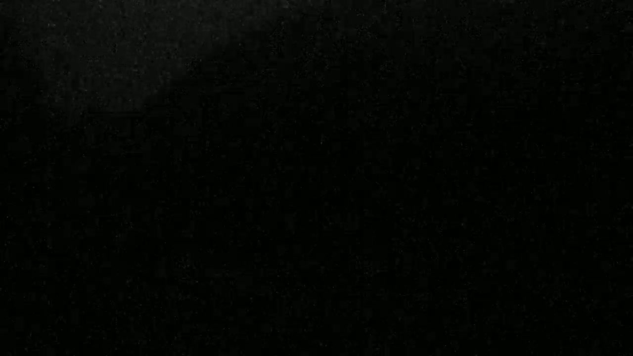 The image is a uniformly dark, almost black surface with a slightly speckled texture.