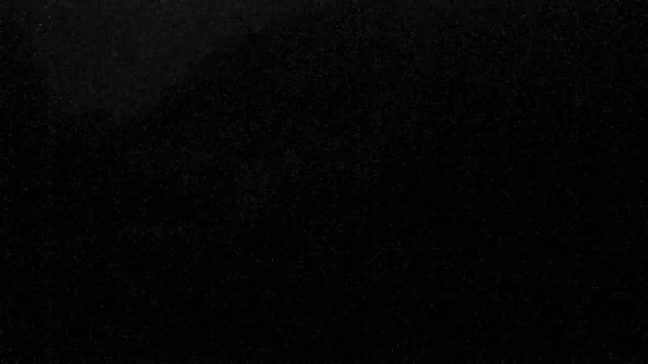The image shows a dark, speckled surface.