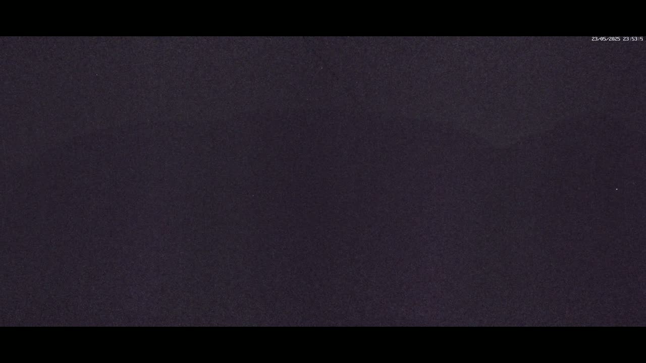 A dark, mostly featureless image shows a uniformly dark-purple or black surface.