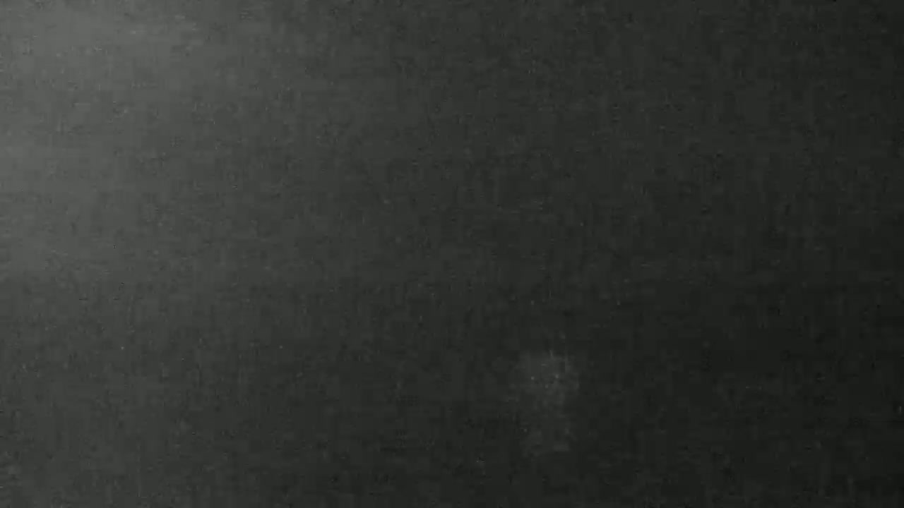 A dark gray, textured surface is shown.