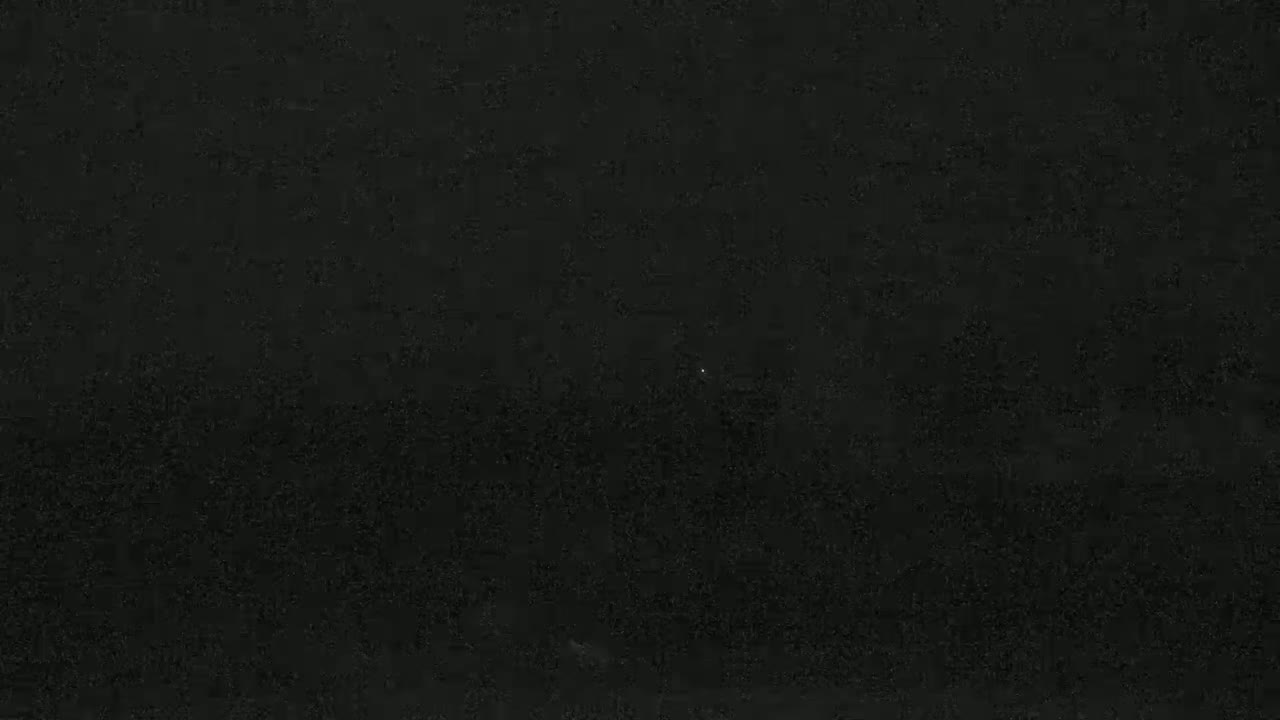 The image shows a dark, possibly nighttime, scene with a slightly grainy texture.