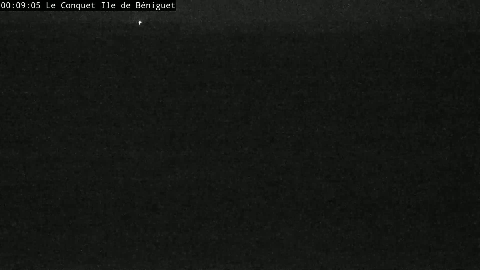 A mostly dark image shows a very faint, possibly starry, night sky.