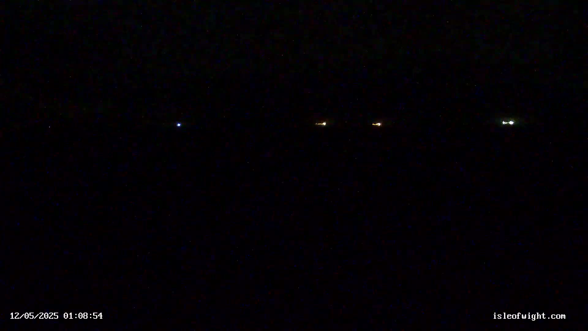 Four small, distant lights are visible in the night sky.