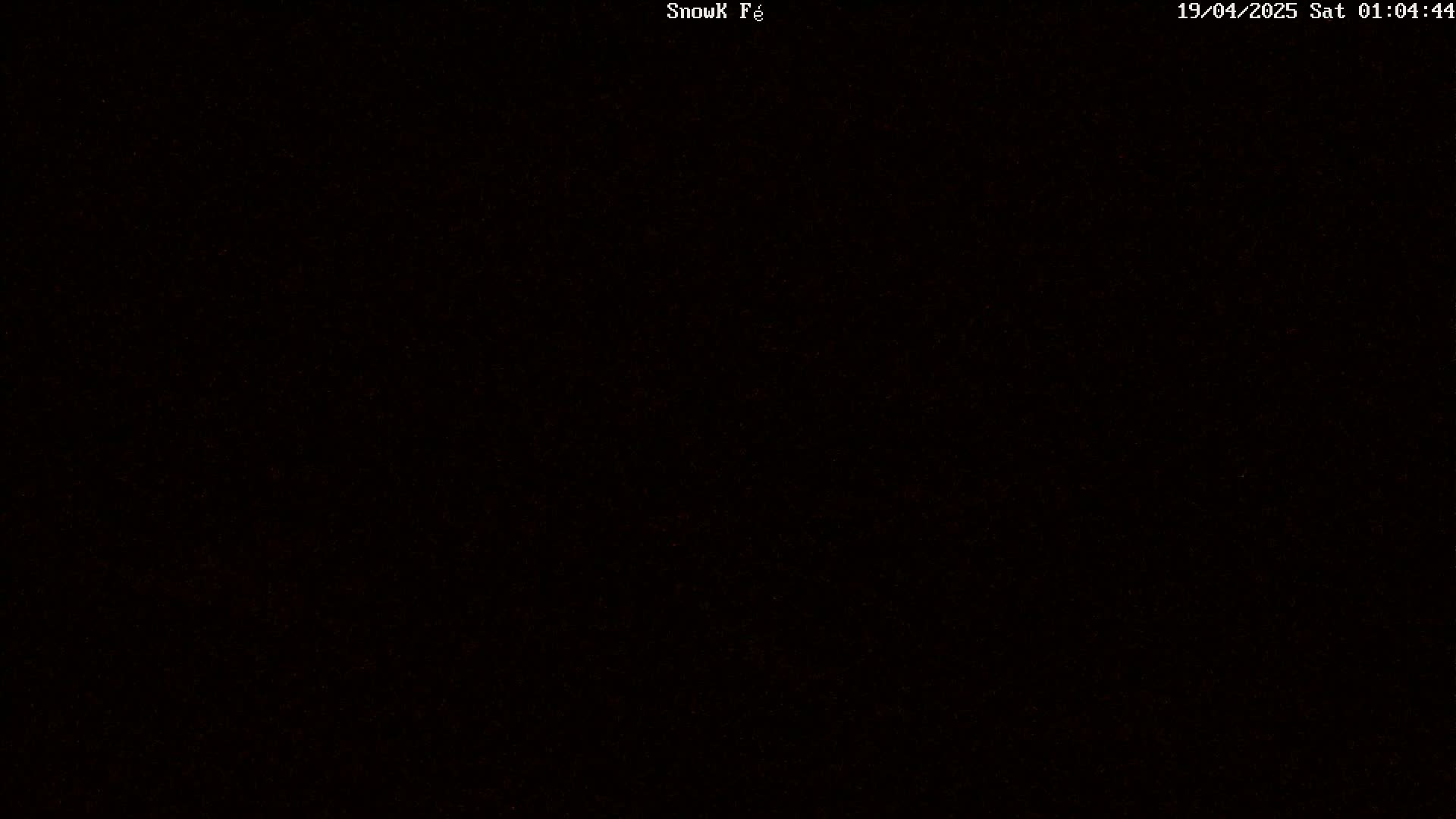 The image is a completely black screen with a few barely visible, scattered, reddish-brown pixels.