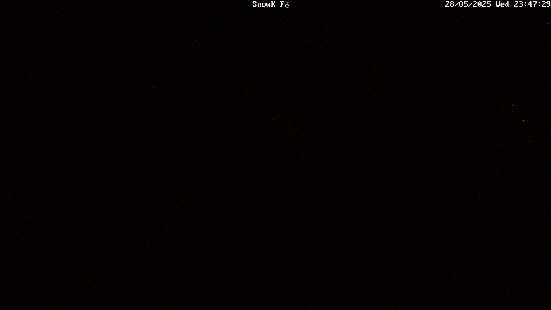 A completely dark image with a few barely visible red specks.