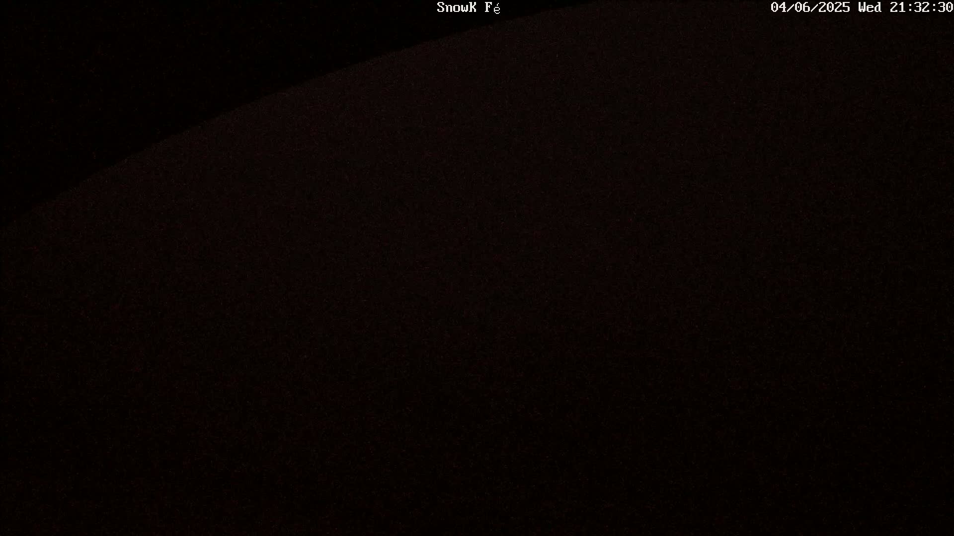 A dark, grainy image shows a mostly black sky at night.
