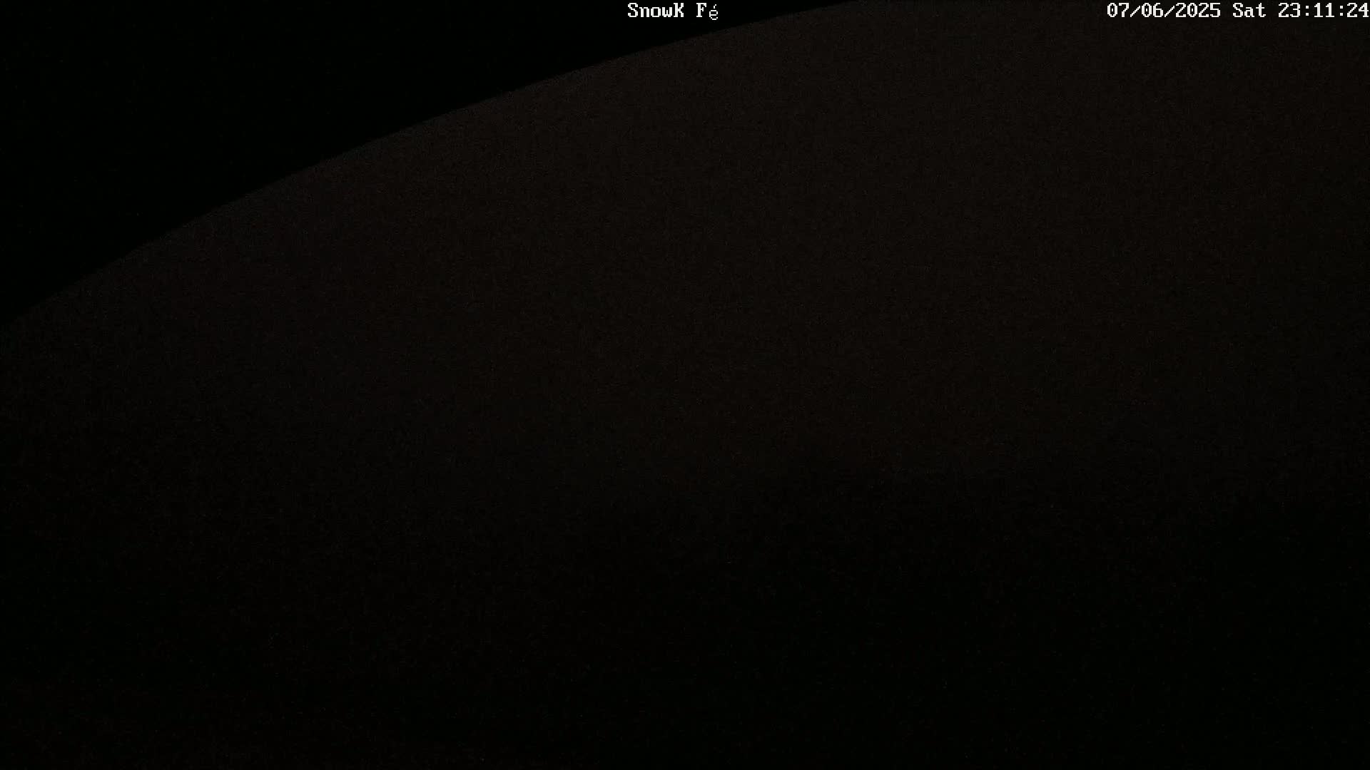 A mostly dark image shows a slightly lighter area at the top, possibly indicating night-time conditions.