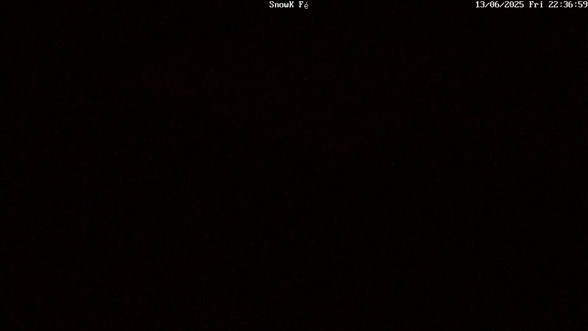 The image is entirely black with a few faint, barely visible specks of light.