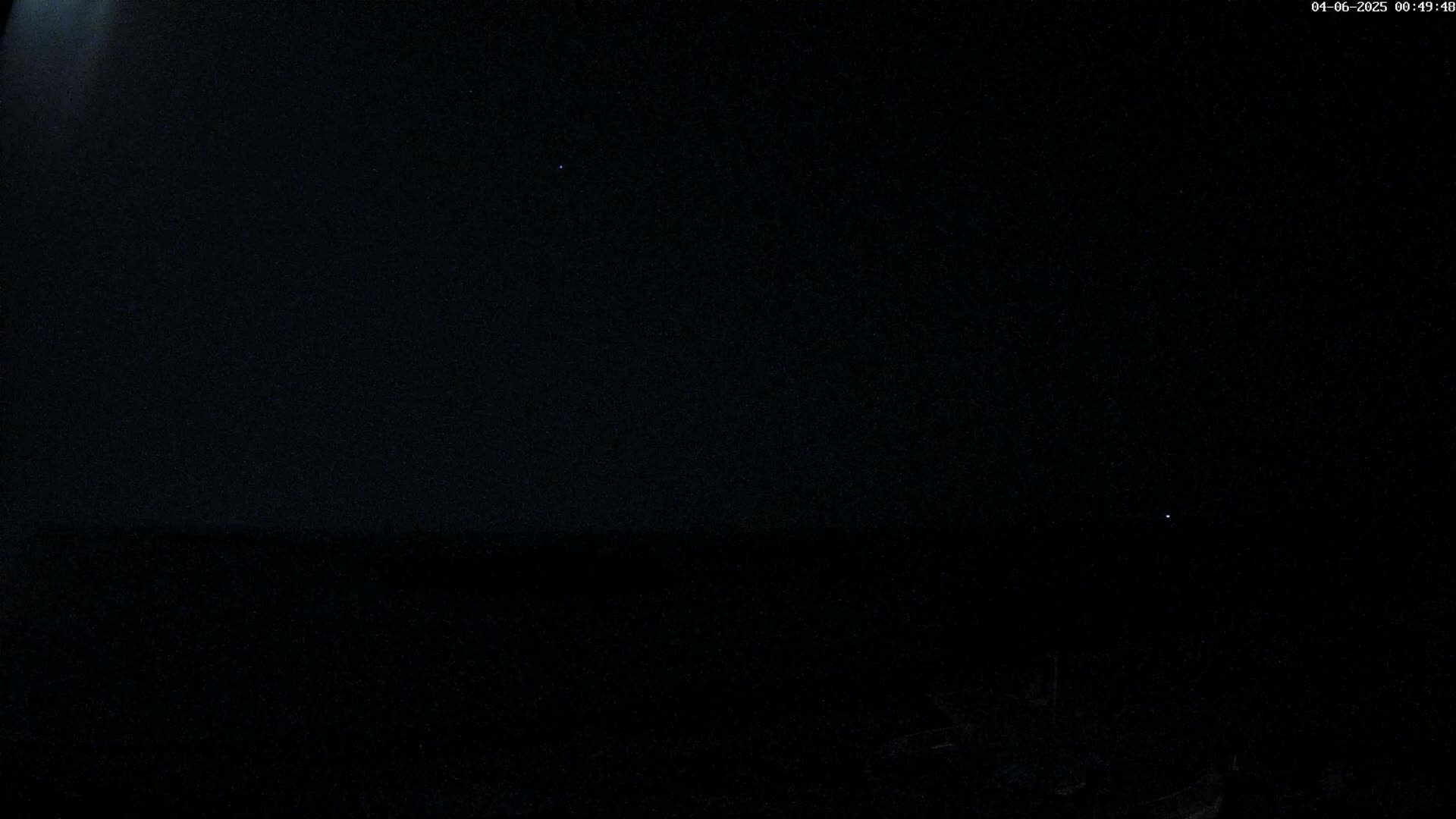 A dark, night sky shows a few faint stars.