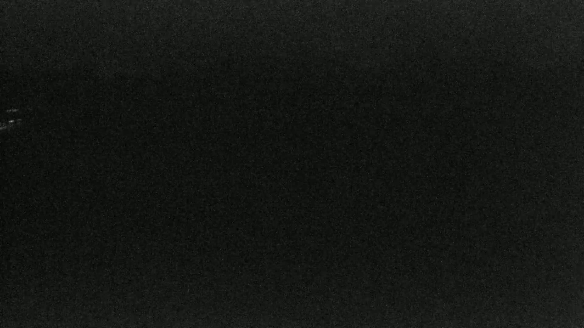 A uniformly dark gray or black textured surface is shown.