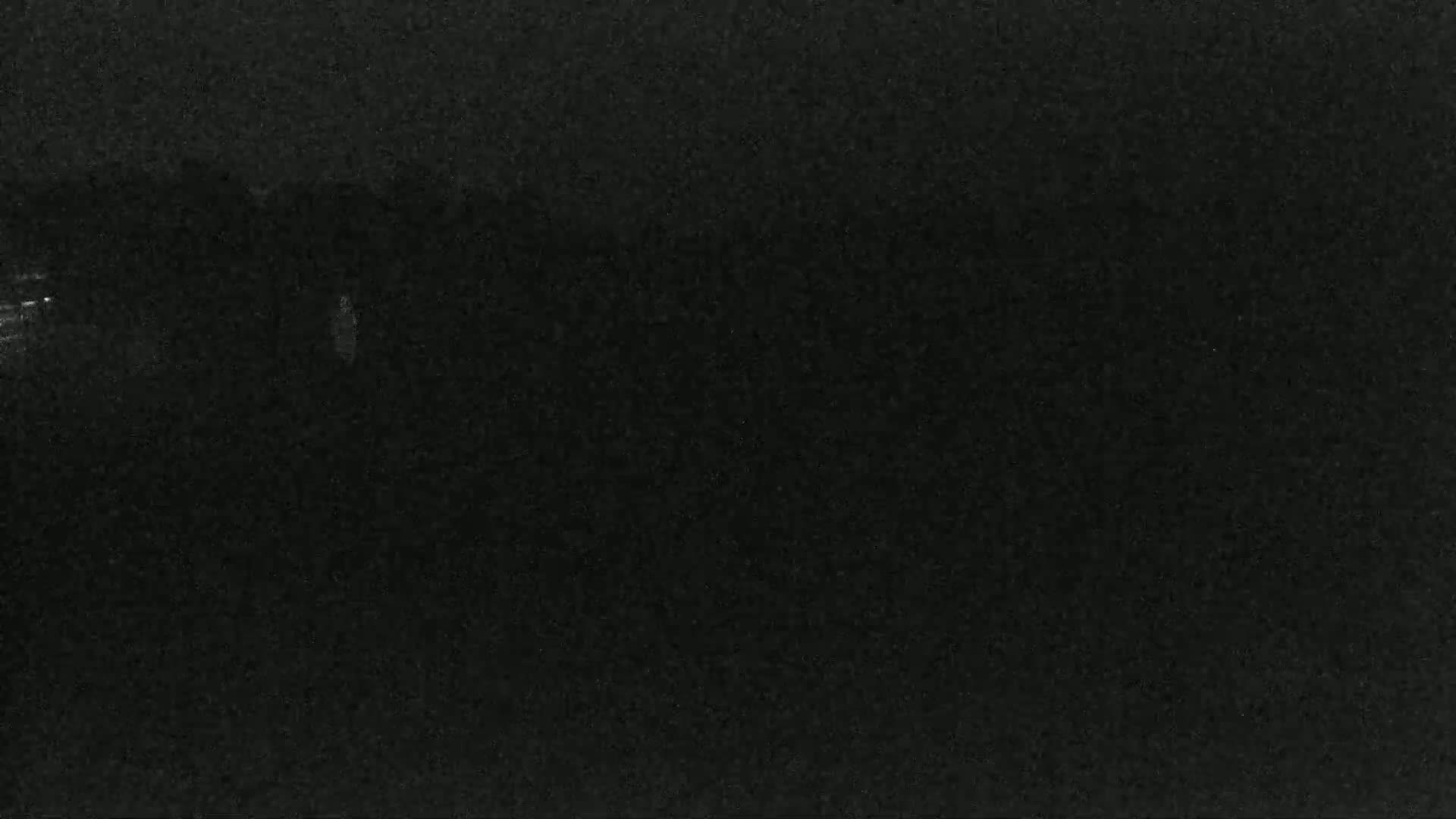 The image shows a dark, possibly nighttime, scene with very little visible detail.