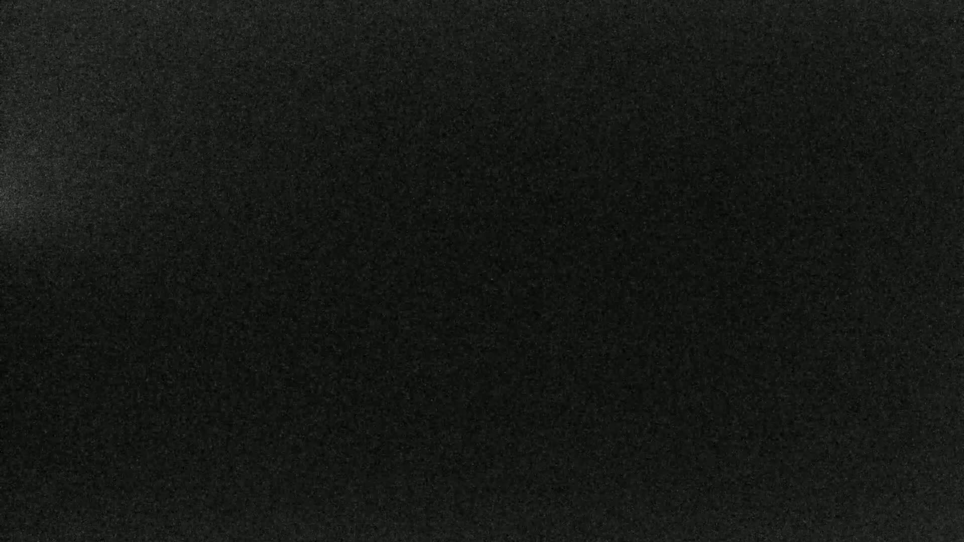 A dark gray, textured surface is shown.