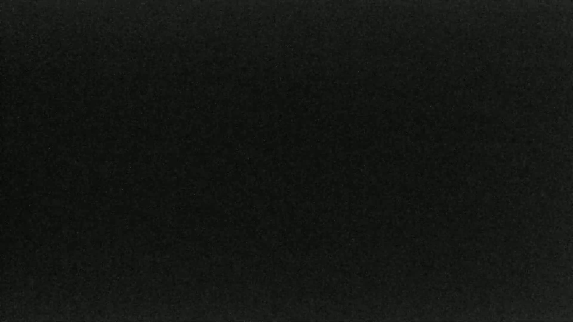 A dark, textured surface is shown.