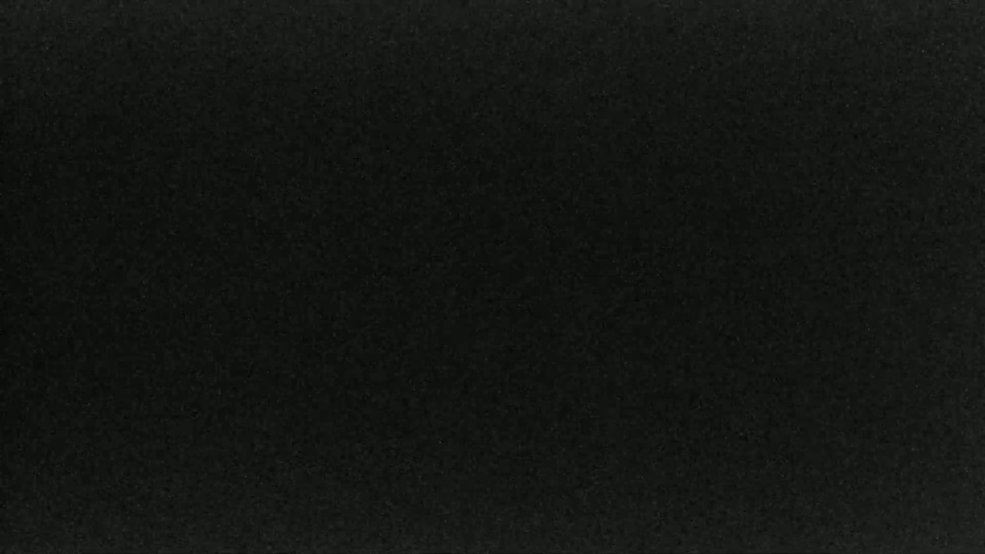 The image shows a dark gray or black textured surface.