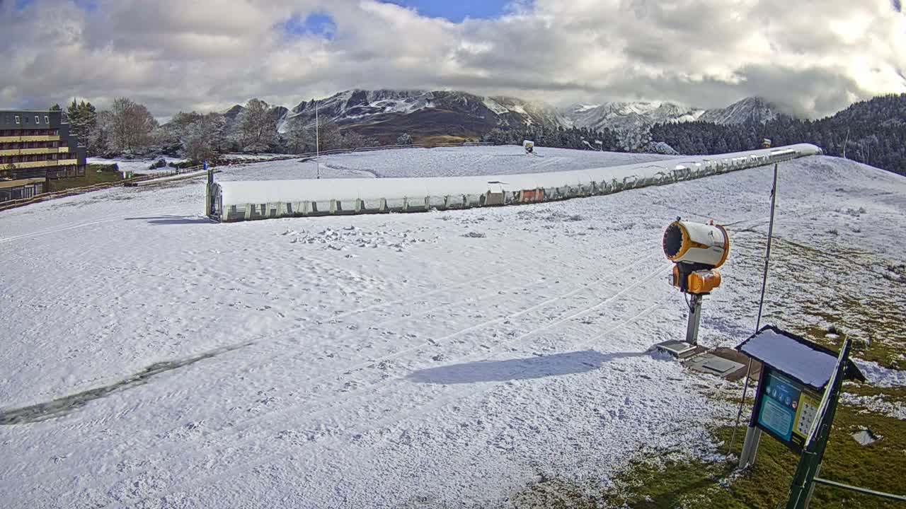 A foggy, outdoor scene shows a mostly obscured grassy field with a few pieces of equipment and a partially visible structure in the distance.