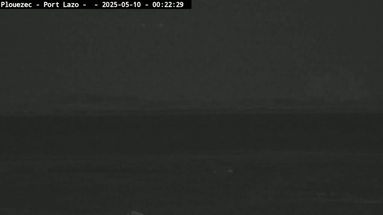 A dark, nighttime scene shows a mostly obscured horizon line under a very dark sky.