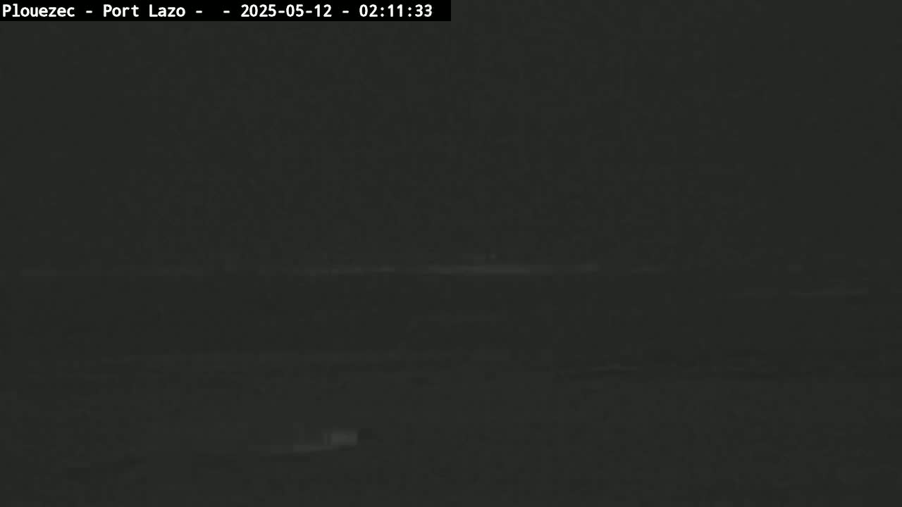 A dark, nighttime outdoor scene shows a flat, indistinct horizon line.