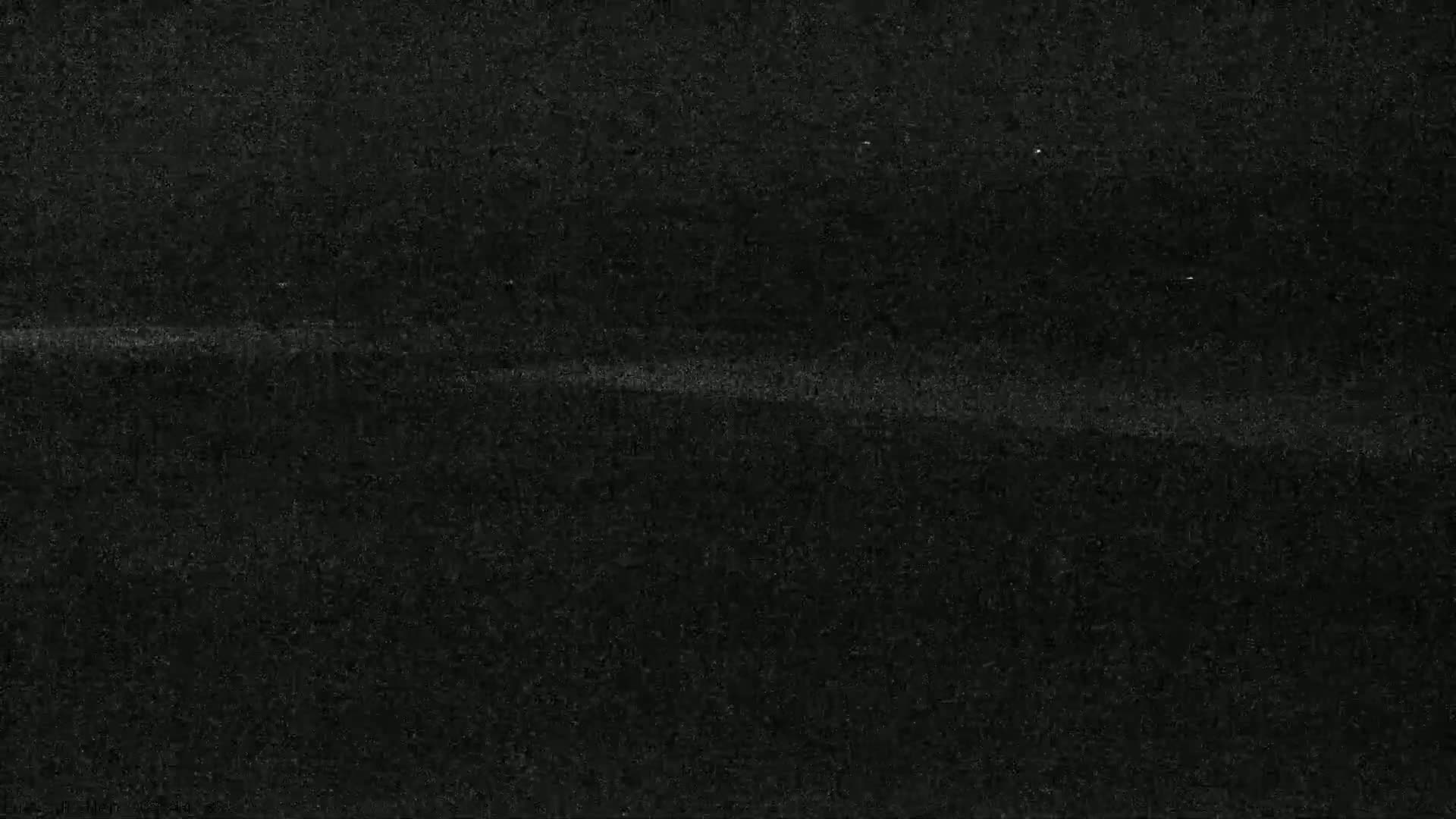 A dark gray textured surface with subtle horizontal lines.