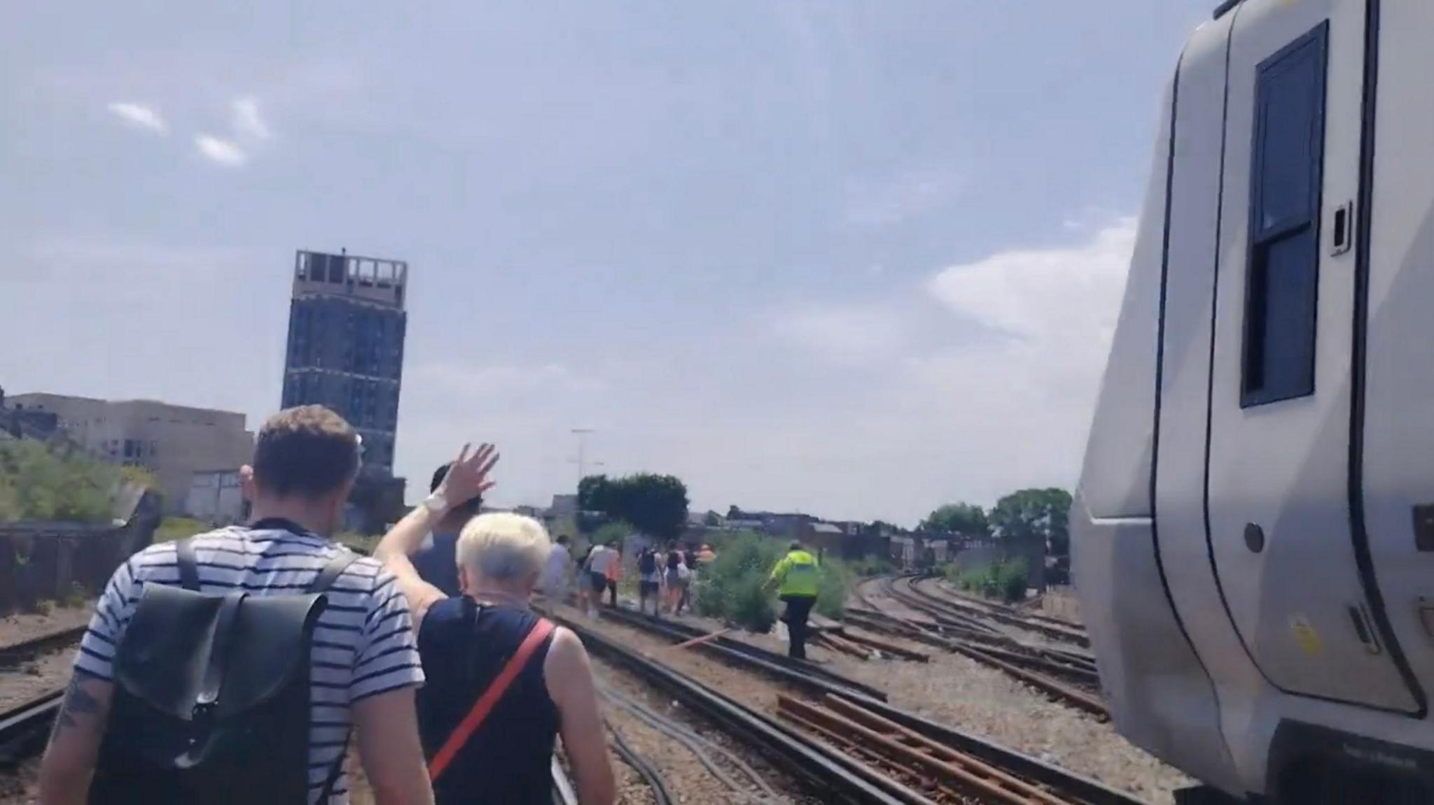 London Train Passengers Evacuated, Walk Tracks on Hottest Day