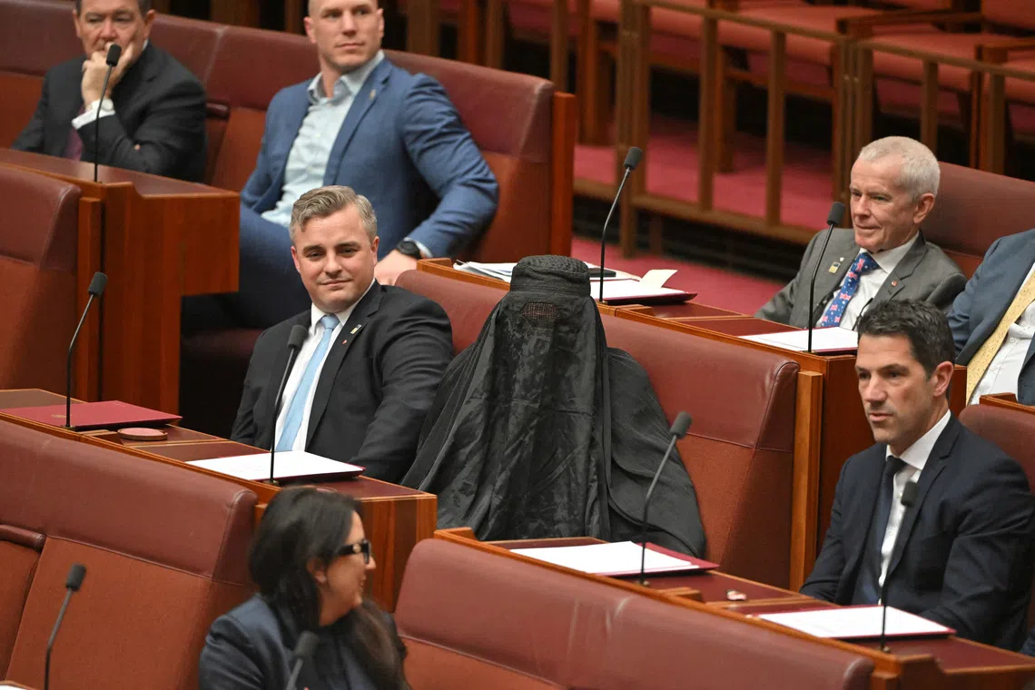 Australian Senator Pauline Hanson Suspended for Burqa Stunt in Parliament Amidst Racism Accusations