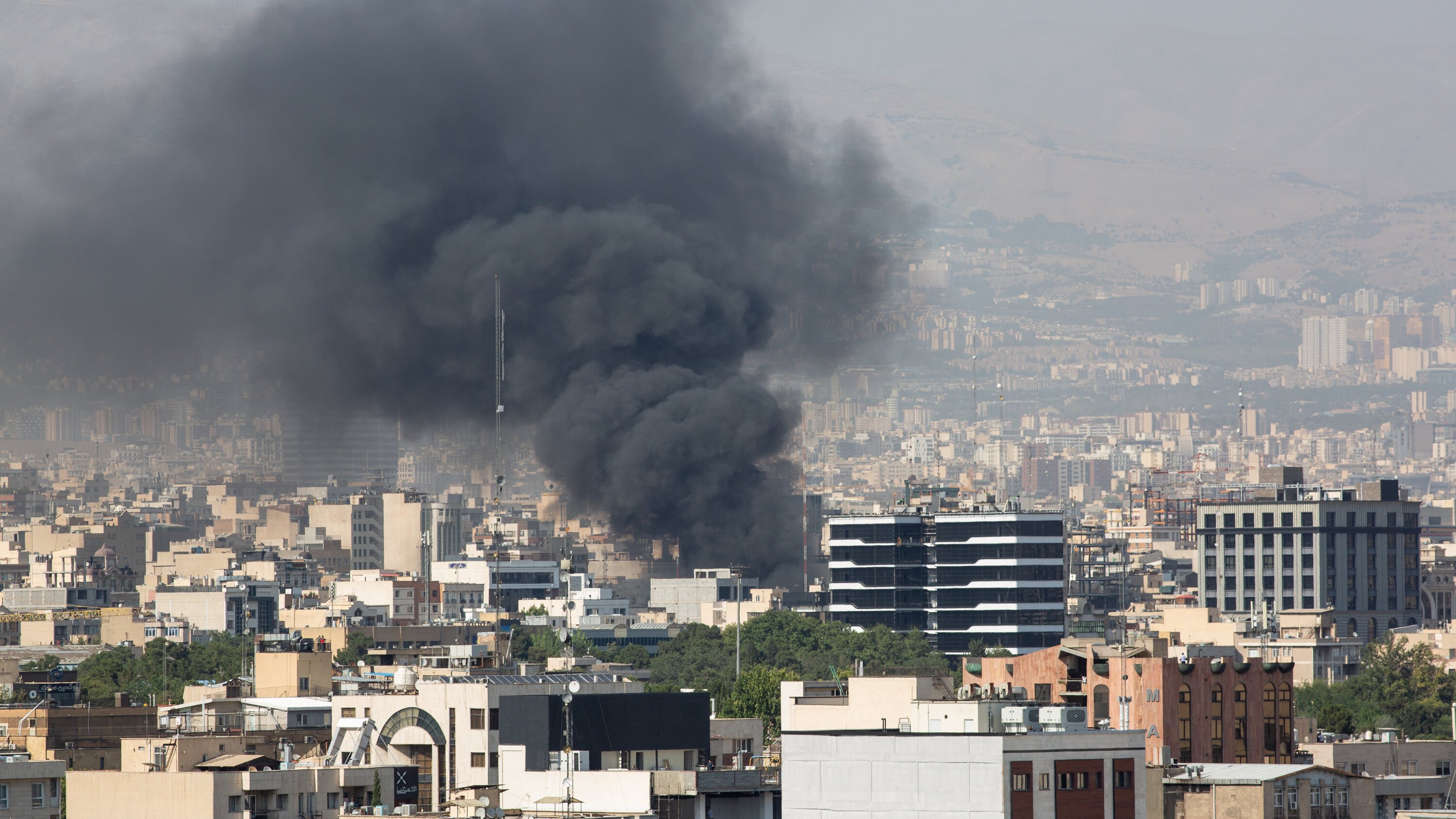 Residents in Tehran watch bombs fall from rooftops