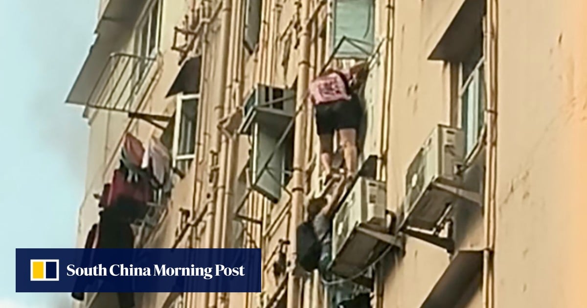 Two women escape window in Hong Kong building fire