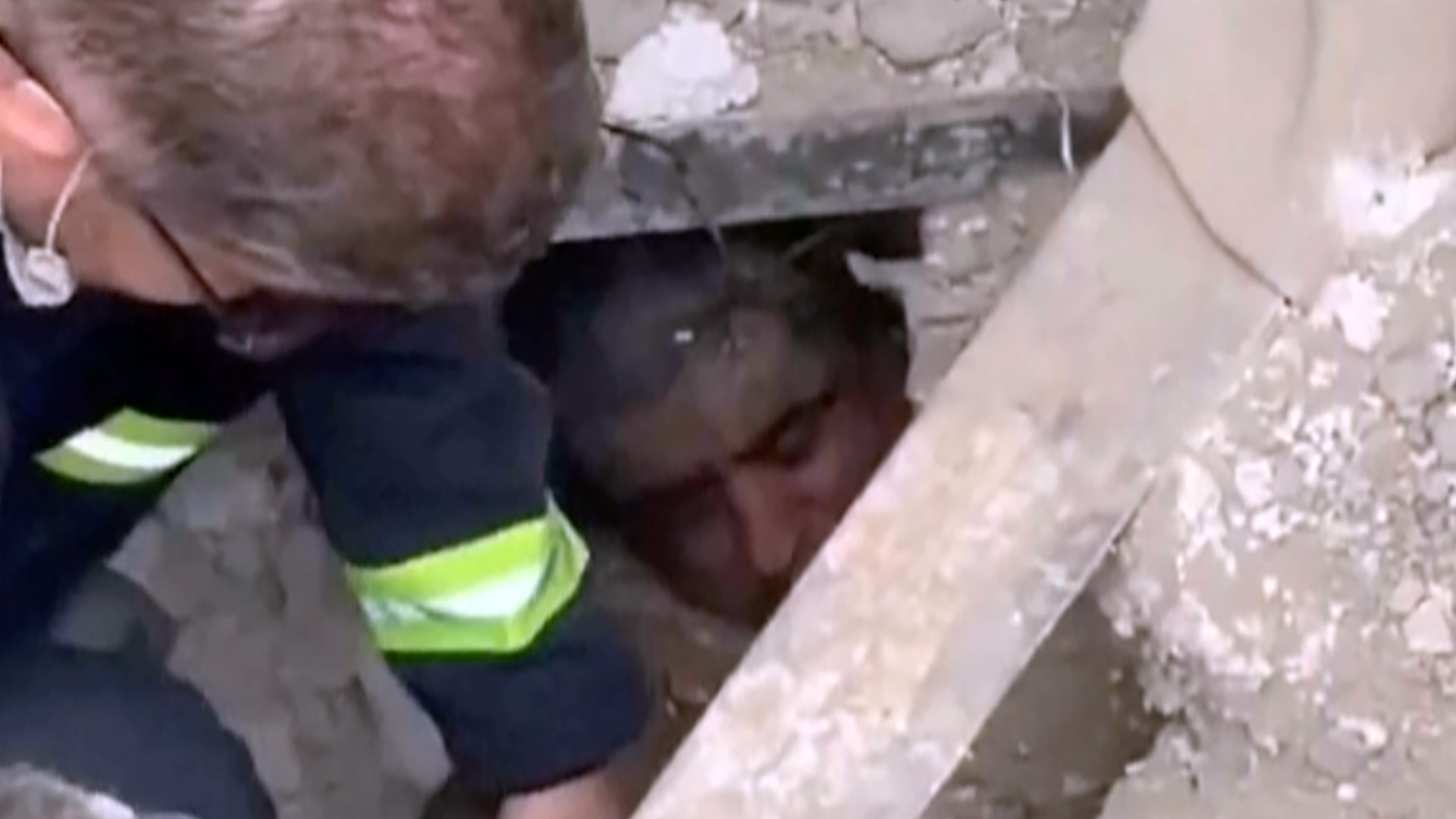 Moment rescuers find man alive under Tehran rubble
